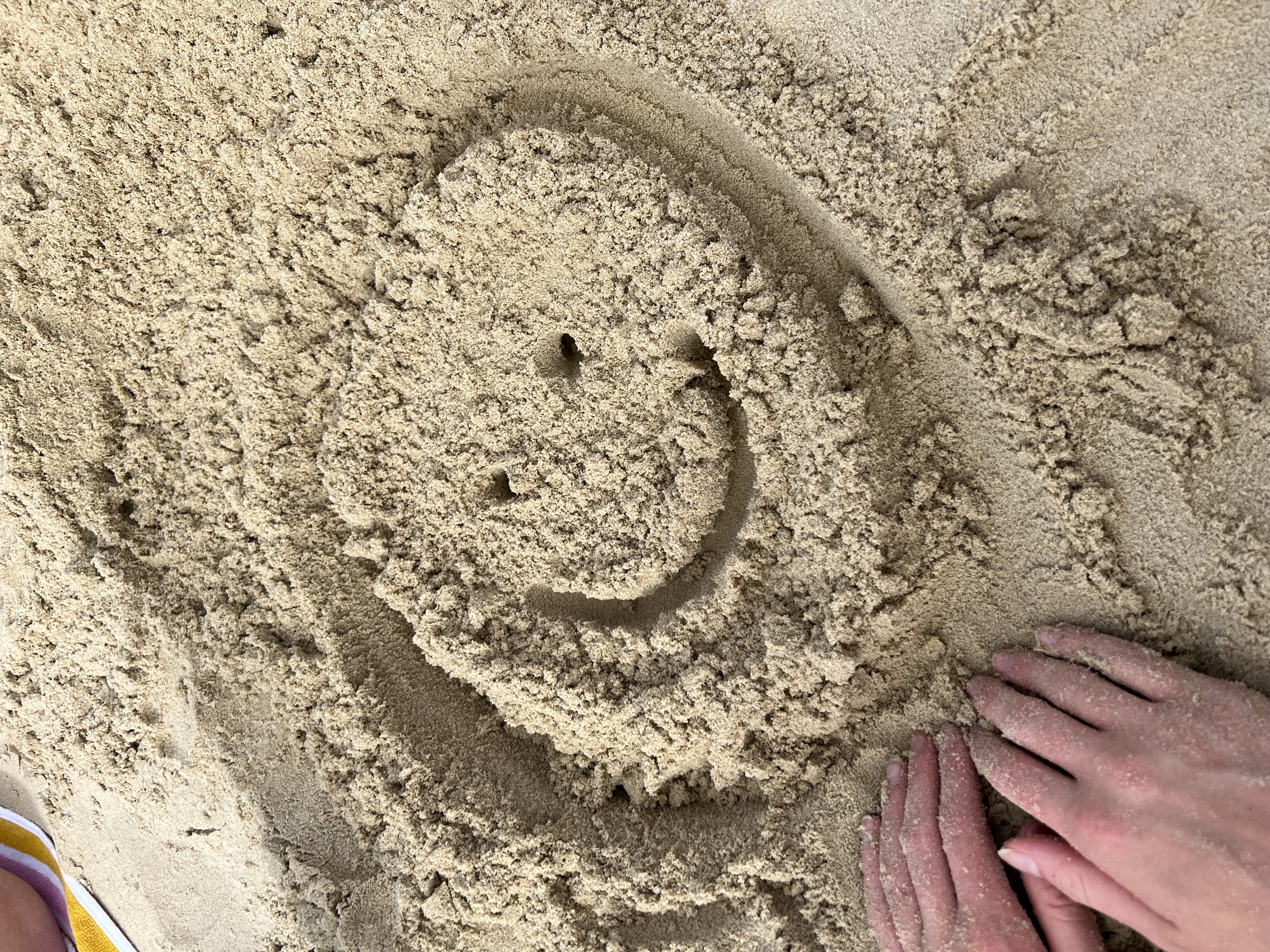 A smiley drawn in the sand